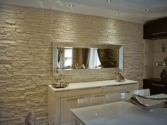 a kitchen with a counter, sink and mirror in it's centerpieces