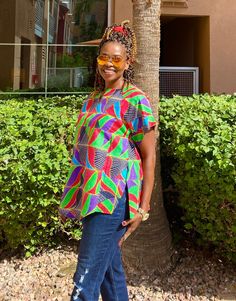 "Unique African print top made from African fabric 100% cotton. This colorful Ankara summer blouse is versatile, flattering, and available for all sizes including plus sizes. Features: Ankara blouse with split neckline. African shirt for women with side slits and fun curved hem. Wear this African top over pants, skirts, shorts, or jeans!  This item will be specially handcrafted for you upon purchase. We appreciate including your bust, waist, and hip measurements at checkout otherwise, we will us Vibrant Cotton Tops For Beach, Colorful Cotton Tops, Multicolor Blouse With Bold Print For Summer, Relaxed Fit Multicolor Cotton Blouse, Vibrant Cotton Summer Tops, Colorful Short Sleeve Cotton Blouse, Vibrant Green Blouse For Vacation, Vibrant Green Cotton Tops, Vibrant Green Cotton Top