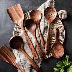 wooden utensils are laid out on a towel