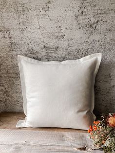 a white pillow sitting on top of a wooden table