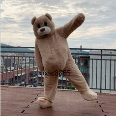 a large teddy bear standing on its hind legs in front of a cityscape