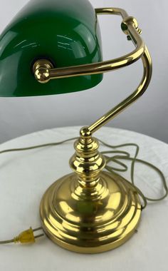 a green lamp sitting on top of a white table