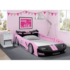 a child's bedroom with pink and black furniture