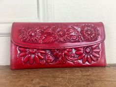 amazing wallet from the 1960-70s. red leather with hand tooled flowers. the flowers are puffy and raised and the craftsmanship makes me swoon! envelope style. front flap opens with a snap. inside has a row of 8 slots for credit cards, identification, frequent shopper cards, etc., etc. there is also a long zippered pocket for all your Washingtons and Franklins + a long slide pocket for receipts + a buttoned change purse + a mirror. tagged ♥ hecho en Mexico genuine leather measurements ♥ 4 inches Tooled Flowers, Tooled Wallet, Celadon Green, Western Chic, Floral Tapestry, Envelope Clutch, Change Purse, Money Clip Wallet, 1960s Vintage