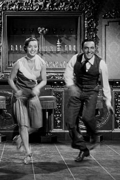 two men and a woman are dancing on the floor