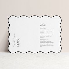 an empty menu card on top of a white counter with a black border around it