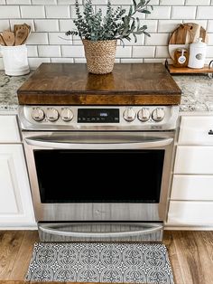 a potted plant sitting on top of an oven