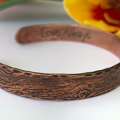 A rustic handmade bracelet that celebrates the beauty of nature and the majesty of the forest with the tree bark texture of this solid copper cuff bracelet. The inside is the perfect place to have your gift personalized with a secret message of love. This engraved copper bracelet is hand forged and finished with a hammered finish to give it a rustic look, perfect for men and women alike. Each bracelet is handmade, and no two will be exactly alike. Also please be aware that colors may vary due to Rustic Stamped Cuff Bracelet Gift, Handmade Nature-inspired Cuff Bracelet Gift, Handmade Nature-inspired Cuff Bracelet As Gift, Handmade Nature-inspired Cuff Bracelet, Rustic Bangle Cuff Bracelet As Gift, Engraved Brown Cuff Bracelet Gift, Rustic Brown Cuff Bracelet Gift, Rustic Brown Cuff Bracelet As Gift, Brown Engraved Cuff Bracelet Gift