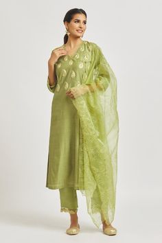 Olive straight kurta with paisley motif embroidered bodice. Comes with embroidered semi-sheer hem pant and dupatta.
Components: 3
Pattern: Embroidered
Type Of Work: Paisley
Neckline: V Neck
Sleeve Type: Three Quarter
Fabric: Organza, Muslin, Chanderi
Color: Green
Other Details: 
Attached lining
Back elasticated pant waistband
Length:
Kurta: 48
Pant: 37.5
Approx. product weight: 1 kg
Occasion: Puja - Aza Fashions V Neck Kurta, Paisley Motif, Kurta Pant Set, Fashion Sketches Dresses, Embroidered Bodice, Sketches Dresses, Green Paisley, Straight Kurta, How To Hem Pants