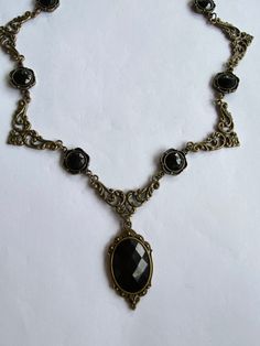 STUNNING FILIGREE VICTORIAN STYLE Black Dark Gold PLATED NECKLACE (BRONZE COLOUR) FASTENS WITH TRIGGER CLASP. The stones are Acrylic PENDANT APPROX  1.75 INCHES (4cm) INCLUDING BAIL LENGTH OF NECKLACE...16..INCHES (40cm)   AS SHOWN... OTHER LENGTHS ALSO AVAILABLE 18 20 22 24 inches  longer lengths have more parts and or stones Also listed as a set with earrings....WITH CHOICE OF 3 SIZES OF EARRINGS. see other listings for the sets I am gradually adding different colour listings as I make them. L Black Pendant Necklace, Acrylic Pendant, Bronze Colour, Moon Bracelet, Metal Clay Jewelry, Bronze Necklace, Diamond Eyes, Black Pendant, Dark Gold