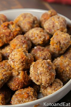 a white bowl filled with meatballs on top of a table