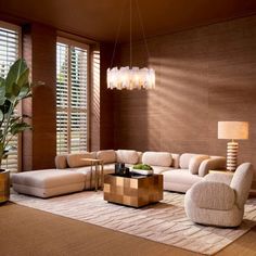 a living room filled with furniture and a large window covered in shades of brown, white and beige