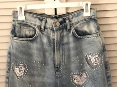 "These are stonewashed jeans made in Argentina. I have cut out hearts and embellished behind the hearts with white lace and sewn on pearl beads. They have frayed edge hems and 5 pockets. Good quality, never worn jeans. Better to wash on sensitive and hang dry. Please check sizing, label says size 28 which is like an 8 I think.  Very High rise. Waist is 28 \" Inside leg 29 \" Legs are quite wide about 10 \" I will ship in a day." Beaded Jeans, Cut Out Jeans, Stonewashed Jeans, Cable Knit Headband, Vintage Wrangler Jeans, High Waisted Jeans Vintage, Rhinestone Jeans, Altered Clothing, Blue Denim Shirt