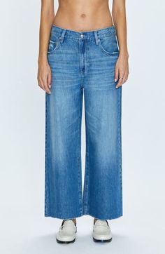 A faded wash and raw-edge hems complete these wide-leg jeans cut from nonstretch denim. 26" inseam; 25" leg opening; 11" front rise; 15" back rise (size 29) Zip fly with button closure Five-pocket style 62% cotton, 38% lyocell Machine wash, tumble dry Imported Chic Medium Wash Flare Jeans With Frayed Hem, Relaxed Fit Dark Wash Jeans With Frayed Hem, Fall Faded Jeans With Frayed Hem, Spring Medium Wash Cutoff Flare Jeans, Wide Leg Flare Jeans With Frayed Hem For Fall, Fall Flare Jeans With Frayed Hem And Wide Leg, High Rise Washed Blue Cropped Jeans With Frayed Hem, Medium Wash Cropped Flare Jeans With Frayed Hem, Fall Washed Wide Leg Cropped Jeans