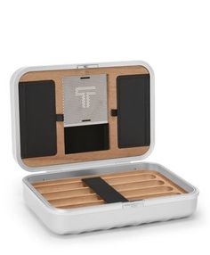 an open white box with compartments filled with wooden trays and dividers on the inside