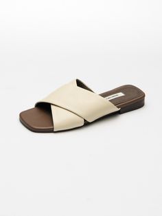 Editor's NotesSEONG YUN JOO is a designer brand specializing in flat shoes with the concept of basic & classic.- Slide styled slippers- Square lined open toe- Criss cross designed strap- Stable fit with wide strap- Comfortable fit with sheepskinMeasurements(in.)KR size- Size: 215MM (US 4.5) - 265MM (US 9.5)- Heel height: 0.55 in.*Fits true to the sizeComposition & Care- Shell: Sheepskin  Cow Leather / Lining: Pigskin / Outsole: Synthetic Rubber- Avoid direct heat and moisture- Keep in a Classic Summer Slip-ons With Cushioned Footbed, Elegant Beige Flat Slippers, Elegant Flat Beige Slippers, Classic Flat Slippers For Summer, Classic Slip-on Mules With Textured Footbed, Classic Flat Mules With Textured Footbed, Classic Summer Slippers With Textured Footbed, Classic Closed Toe Summer Slippers, Summer Classic Closed Toe Slippers