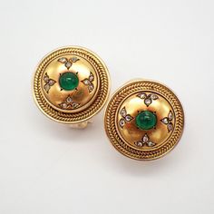 Vintage 20k (.833) yellow gold round form earrings, decorated with Emerald cabochons and accented with Diamonds, featuring foliate pattern. The earrings were tested with an XRF machine, resulting 20k yellow gold with 14k yellow gold omega clasps. The clasps were soldered on as a replacement and display some minor discoloration (please see pictures). These spectacular earrings are 19 mm in diameter, weighing a total 13.8 grams.  The Emeralds are 4.5 mm in diameter, and 24 rose-cut Diamonds are 1.3 mm in diameter each. EA3487 Luxury Round Cabochon Clip-on Earrings, Formal Yellow Gold Round Cabochons, Formal Gold Clip-on Cabochons, Elegant Gold Domed Cabochons, Vintage 22k Yellow Gold Earrings, Vintage 22k Gold Earrings, Elegant Yellow Gold Hallmarked Cabochons, Elegant Yellow Gold Clip-on Earrings With Cabochon, Elegant Gold Oval Cabochons