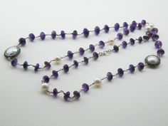 Amethyst is paired with a pearl in a necklace that is perfect for artists This is a stunning, natural necklace made from high-quality materials, amethyst, baroque pearls, Amethyst is associated with the Magical. Length 15 inç. ( 38 cm. ) Neck circumference 30 inç. (76 cm. ) Sending me requests and suggestions, please feel free to convo The product will be sent within a gift box and a gift bag For other inquiries, please visit the shop policies Thank you for visiting our shop http://www.etsy.com/ Elegant Purple Necklace For Wedding, Long Gemstone Beads Necklace For Wedding, Elegant Amethyst Rondelle Jewelry, Purple Pearl Single Strand Jewelry, Purple Single Strand Pearl Jewelry, Long Wedding Necklace With Gemstone Beads, Elegant Amethyst Necklace With Pearl Pendant, Purple Gemstone Necklace For Wedding, Formal Amethyst Gemstone Bead Necklace