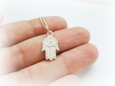 "Hamsa Hand Necklace Sterling Silver - Hand of Fatima Sterling Silver - Protection Jewelry Sterling Silver - Lucky Charm Necklace - Hamsa Charm Necklace Love tiny and delicate charms? Then this is the necklace for you! A small sterling silver Hamsa hand (solid and with good weight) , slightly oxidised, that comes with a rhodium plated 18'' chain. (All my chains are made in the US ) Hamsa, also romanized khamsa, is an Arabic word that literally means \"five\", but also the five fingers of the han Symbolic Silver Necklace With Delicate Chain, Handmade Small Sterling Silver Necklaces, Small Handmade Sterling Silver Necklaces, Small White Sterling Silver Necklaces, Small White Sterling Silver Necklace, Delicate Handmade Silver Charm Necklaces, Sterling Silver Necklaces With Charms, Delicate Sterling Silver Charm Necklaces With Lobster Clasp, Delicate Handmade Sterling Silver Charm Necklace