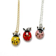 "Tiny ladybug charms in 3 different colors: Red with black spots Pink with hearts Yellow with smiley face and spots Handmade ceramic charms. Fired with underglaze colors, midfire glaze, and gold overglaze. Dimensions The average length of the charms is around 5/16\"(8mm) without the antennae. Chains available:  Sterling Silver and Gold-Filled in 16, 18, 20, and 22 inches Materials Porcelain Clay Underglaze Colors Mid-Fire Glaze Gold Overglaze High Temp. Wire Care Instructions While porcelain cla Cute Hand Painted Red Jewelry, Cute Red Hand-painted Jewelry, Cute Red Hand Painted Jewelry, Whimsical Red Hand Painted Jewelry, Cute Handmade Red Charm Necklace, Cute Red Handmade Charm Necklace, Cute Handmade Red Charm Necklaces, Clay Underglaze, Ladybug Jewelry