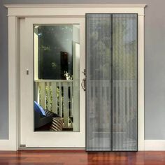 an open sliding glass door on a wooden floor