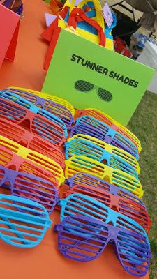 many pairs of sunglasses are on display at an outdoor event for children to enjoy the day