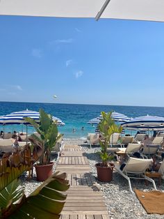 the beach has many umbrellas and chairs on it