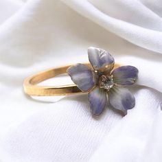 We love great conversion pieces such as this! Originally a stick pin & repurposed into a dainty fashion ring. This beauty features magnificent enamel work along with a tiny diamond in the center of the flower. Metal: 10K Yellow Gold Shank Width: 1.65mm Finger Size: 7 Weight: 2.0 Grams Some Minor Enamel Loss On Flower Item: 768TMUP Vintage Gold Enamel Ring With Rose Cut Diamonds, Yellow Gold Enamel Flower Jewelry, Enamel Flower-shaped Jewelry For Wedding, Heirloom Enamel Ring For Anniversary, Enamel Flower Shaped Wedding Jewelry, Flower-shaped Enamel Jewelry For Wedding, Flower Shaped Enamel Wedding Jewelry, Flower Shaped Enamel Jewelry For Wedding, Heirloom Enamel Jewelry For Anniversary