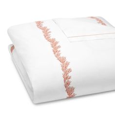 an image of a bed with white sheets and orange trimmings on the edges