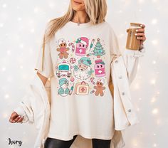 Get festive with this adorable nurse Christmas shirt featuring a winking Santa Claus, gingerbread, and snowman all on a cozy Comfort Colors nurse shirt. Perfect for spreading holiday cheer in the NICU or any department, this Christmas nurse t-shirt is an ideal addition to your collection of cute nurse shirts. Whether you're a NICU nurse, pediatric nurse, or just love RN tees with a holiday twist, this design makes for a perfect holiday nurse look. Great for work or as a fun holiday gift, this Co Sicu Nurse, Cute Nurse Shirts, Nurse Pediatric, Nurse Crewneck, Nurse Tshirt, Nurse Shirts, Pediatric Nurse, Cute Nurse, Nurse Christmas