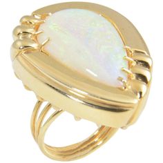 Large statement cocktail ring featuring a pear shaped opal mounted in a 1970s 14k yellow gold stylized frame. US Size: 6. It can be resized. Yellow Gold Opal Ring, Ladies Bangles, Boulder Opal Ring, Diamond Bracelet Design, Amethyst And Diamond Ring, Opal Ring Gold, Gold Statement Ring, Gold Cocktail Ring, Gold Cocktail