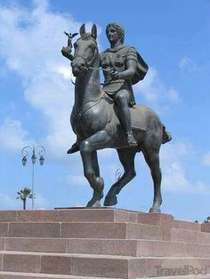 a statue of a man riding on the back of a horse