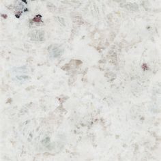 a white marble textured surface with red and black dots on the top right corner