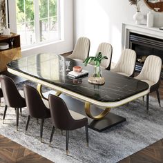 a dining room table with chairs and a fireplace in the backgroung area