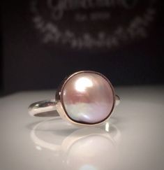 Elegant Pink Cabochon Rings, Elegant Pink Opal Sterling Silver Ring, Elegant Pink Opal Ring In Sterling Silver, Elegant Cabochon Ring With Round Stone, Elegant Gemstone Stackable Rings With Round Shape, Elegant Stackable Moonstone Ring In Sterling Silver, Elegant Stackable Sterling Silver Moonstone Ring, Elegant Pink Moonstone Sterling Silver Ring, Unique Round High-luster Jewelry