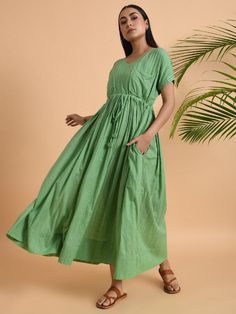 A free size long maxi dress with drawstring at the waist and double pockets Garment measurements (in Inches): Free Size: Bust: 50", Waist: 48", Length: 52" Fabric: Cotton Dobby Color: Green Fit: Model height is 5'7" Model is wearing a size S Loose and comfortable fit. Instructions: Hand wash separately in cold water Note: Available in other colors Pants not included with the product Pants can be bought separately This product will be shipped within 20-25 days of order placed.