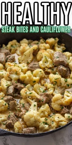 a skillet filled with meat and cauliflower on top of a marble counter