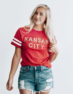 Red Kansas City Sequin Football Tee Red Varsity T-shirt With Team Name, Red Varsity T-shirt For Game Day, University Red Varsity Tops With Letter Print, Red Varsity T-shirt For Fan Gear, Cotton Varsity Slogan Tops, Cotton Varsity Tops With Slogan, Red Text Print Top For College, Red School Spirit T-shirt With Text Print, Varsity Style Red Top With Graphic Print