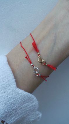 This simple red string bracelet makes a great gift. D E T A I L S *Made with a pure silk cord that has been twisted for strength. (Cord is 0.7mm thick). *Choose between sterling silver,  gold filled or rose gold filled components. *S I Z I N G H E L P: This bracelet works best with a snug fit. So measure you wrist exactly and to this add 1/2 an inch to account for flex. P A C K A G I N G: All our products are gift ready. T E R M S* O F* S A L E S & F A Q https://etsy.me/2PuWBv6 F O L L O W Instagram: @Allaboutevecreations and  Facebook: www.facebook.com/AllAboutEveCreations Pinterest: www.pinterest.com/allaboutevecreations Red String Of Fate Bracelet, String Of Fate, Red String Of Fate, How To Make Red, Kabbalah Bracelet, Braided Bracelet Diy, Braided Rope Bracelet, Pretty Jewelry Necklaces, Red String Bracelet