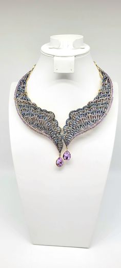 "Angel Wing Necklace, Swarovski Crystal Statement Necklace, Lace Collar Necklace, Filigree Choker, Butterfly Wing, Heidi Daus Collar, Luxury Measurements: 17-3/4\"L x 2-1/2\"W with 3-3/4\" extender. Bib is 4\"L x 6-1/2\"W. Metal Type: Bronze Tone Findings: Hook Closure Finish: Polished, Oxidized This Heidi Daus necklace truly belongs in an art museum. The three-dimensional collar shape, the THOUSANDS of HANDSET SWAROVSKI CRYSTALS, the SHEER SIZE and SPARKLE all make these pieces rival some of the most beautiful and expensive luxury jewelry in the world. Shades of crystal include light purple amethyst and blue Montana sapphire. EVERYONE will believe they are the REAL DEAL GEMSTONES as the sparkle, color and quality is simply MAGNIFICENT. The collar has multiple hinges throughout to form fit Crystal Necklace With Intricate Design For Parties, Dazzling Crystal Necklaces With Intricate Design, Luxury Jeweled Bridal Necklace For Formal Occasions, Luxury Jeweled Bridal Necklace Gift, Luxury Bridal Necklace With Intricate Design, Luxury Silver Jeweled Bridal Necklace, Luxury Crystal Jewelry With Intricate Design, Luxury Bridal Necklace With Intricate Crystal Design, Luxury Purple Crystal Elegant Necklace