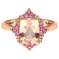 This lovely ring from Gin & Grace offers a large emerald-cut Genuine morganite center stone surrounded by round-cut Genuine pink sapphires and Natural white diamonds. The 14-karat rose gold construction of this jewelry is finished with an attractive high polish. Gemstone colors: Pink Gemstone shapes: One prong-set Cushion-cut Genuine morganite measures 7 mm wide x 9 mm long Gemstone weight: 2 carats 12 prong-set round cut natural pink sapphires each measure 1.5 mm Gemstone weight: 0.22 carat Tot Luxury Rose Gold Sapphire Ring With Morganite, Luxury Morganite Sapphire Ring As A Gift, Luxury Pink Gold Diamond Ring With Rose Cut Diamonds, Luxury Blush Ring With Center Stone, Luxury Pink Rings With Rose Cut Diamonds, Luxury Pink Topaz Ring With Prong Setting, Luxury Pink Topaz Ring In Classic Style, Luxury Blush Rings With Center Stone, Luxury Rose Gold Birthstone Ring With Rose Cut Diamonds