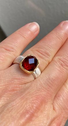 A beautiful, deep red garnet in an unusual shape, rectangular and a great cut. Something else :-) It is set in 750 gold and sits on a silky matt 925 silver ring. The base of the setting is also made of silver to bring out even more light from the stone. To fall in love Made with love in my workshop. garnet 750 gold 925 silver Ring size 55 mm Inner diameter 17.25mm Red Gemstone Ring With Rectangular Stone, Red Rectangular Gemstone Ring, Rectangular Ruby Ring Gift, Rectangular Ruby Ring For Gift, Rectangular Garnet Rings In Red, Red Ruby Ring With Rectangular Stone For Gift, Rectangular Red Ruby Ring Gift, Gift Ruby Ring With Rectangular Stone, Square Cut Ruby Ring In Red