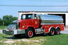 a red fire truck parked in front of a garage