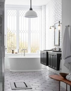 a bathroom with white walls and flooring next to a bathtub in the corner