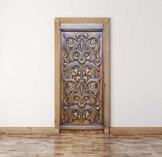 an old wooden door in the corner of a room with white walls and wood floors