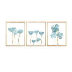 three framed paintings with blue flowers on them