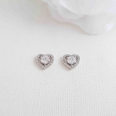 Heart-shaped Earring Studs in Cubic Zirconia Add a romantic touch to your look with heart earrings. These beautiful open-heart earrings with a round centre stone are made with shiny clear cubic zirconia in a silver finish. The heart shaped earrings measures 10.5mm and weigh less than 2 grams an earring, which are lightweight and easy to wear. The heart earrings are a timeless piece and must-have stud earrings in your fashion jewelry collection. Measurement:- 1 cms or 1/2 and inch Heart Shape Earrings, Poetry Design, Open Heart Earrings, Romantic Heart, Heart Shaped Earrings, Earring Studs, Open Heart, Pretty Earrings, Jewellery Collection