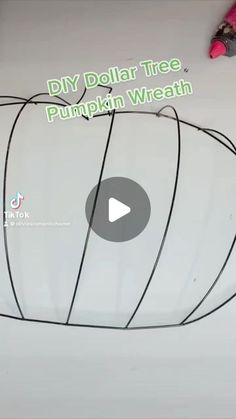 a video demonstrating how to make a diy dollar tree pumpkin wreath with wire and yarn