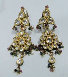 Vintage antique solid 22 carat Gold 'Katsari' stud earring pair from 'Mewar state' Udaipur Rajasthan India. Great Handmade Workmanship all over the piece. Beautiful design & seted Rose cut real Diamonds in it. Very nice Red,green & blue color Enamel work at back side of earring. Attached Ruby,emerald,sapphire & pearl beads in all the Bottom loops. Beautiful workmanship earring pair in Good condition,Great for your jewelry collection. Weight-24 Grams (0.84 ounce) Length-6.3 cm (2.48") Real Gold Jewelry, 22 Carat Gold, Gold Jewelry Earrings, Ruby Emerald, Ruby Earrings, Rajasthan India, Udaipur, Natural Blue Sapphire, Bridal Fashion