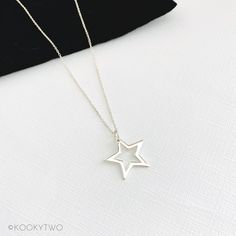 "Gorgeous shiny sterling silver open star necklace. This lovely simple star charm is available on a choice of sterling silver chains and lengths. A stylish necklace perfect for everyday styling, to compliment your look. Select a length to suit your style, and wear solo or layer with other necklaces. Lovely necklace you'll love to wear or love to give. ☆ Select chain style and length when adding to basket. ☆ P R O D U C T ∙ D E T A I L S  ∙ Metal: 925 Sterling Silver  ∙ Star approximately 20mm  ∙ Necklace comes with two number charms  ∙ Spring clasp fastening  ∙ Hypoallergenic ∙ Nickel and lead free  ∙ Gift-ready in our stylish white KookyTwo box  ∙ Handmade by us in our UK studio ☆ C H A I N ∙ L E N G T H  Length: Measurement from end to end including the clasp.  ∙ Trace Chain:  18\"   ∙ C Silver Star Print Necklace, Silver Necklace With Star Print For Gift, Silver Star Print Necklace Perfect For Gift, Silver Star Print Necklace For Gift, Minimalist Star Shaped Jewelry With Star Charm, Silver Jewelry With Star Print As Gift, Silver Star Print Jewelry As Gift, Everyday Star Charm Necklace, Minimalist Star Necklace For Everyday